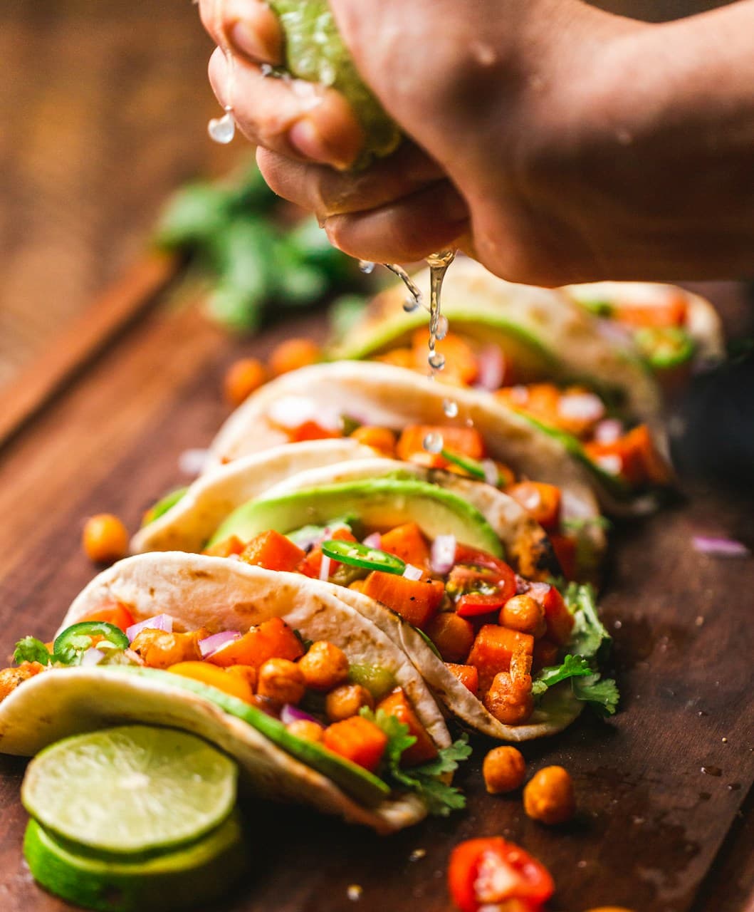Three tacos with lime